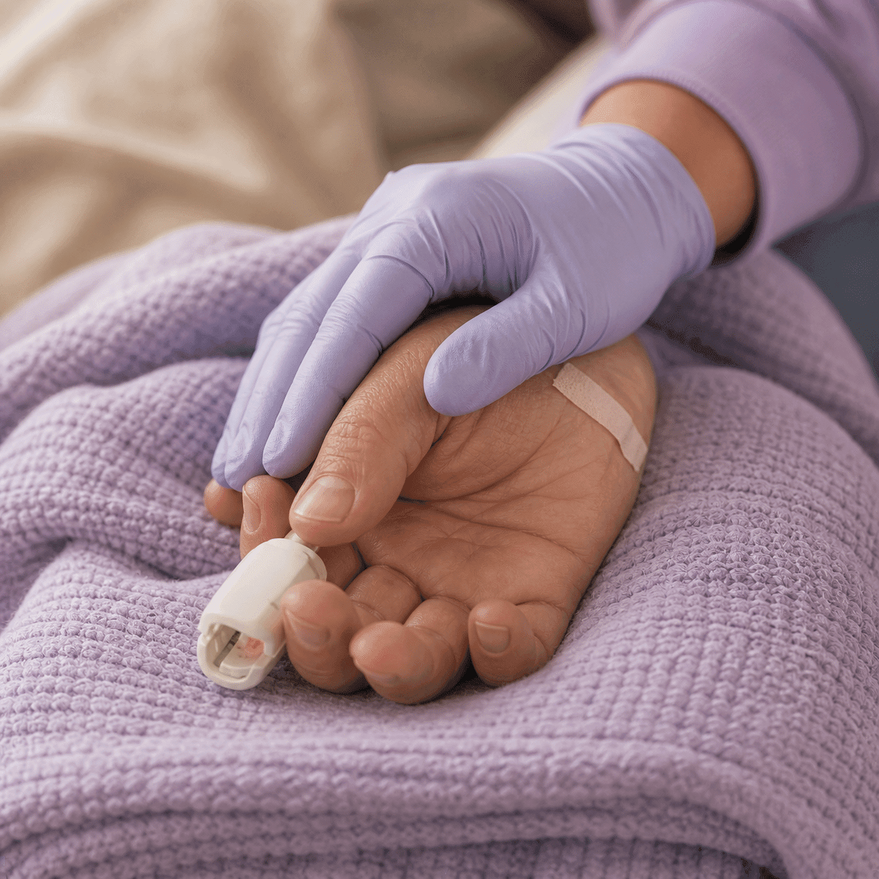 Gentle hand of a clinician resting beside a deeply relaxed patient's hand during IV sedation in Barrie, Ontario
